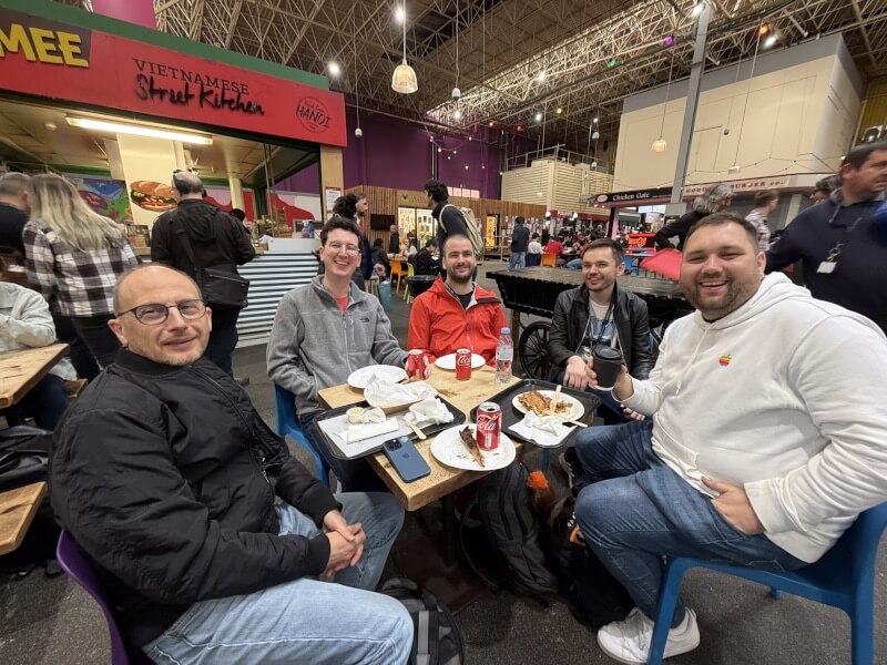 Eric, Will, Bas, Joseph, and Matt with empty plates at the market.