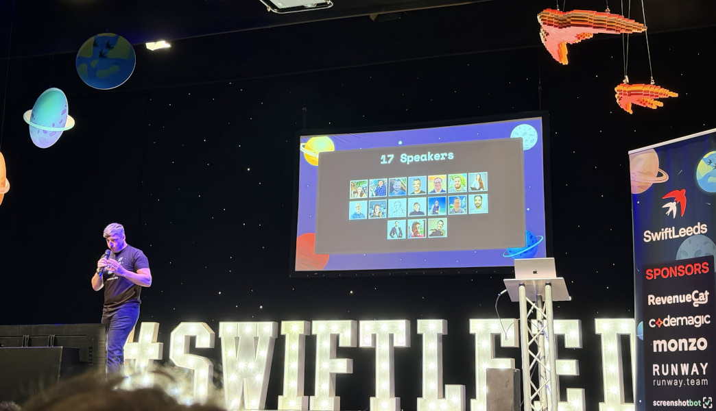 Adam on stage giving the introduction to Swift Leeds.