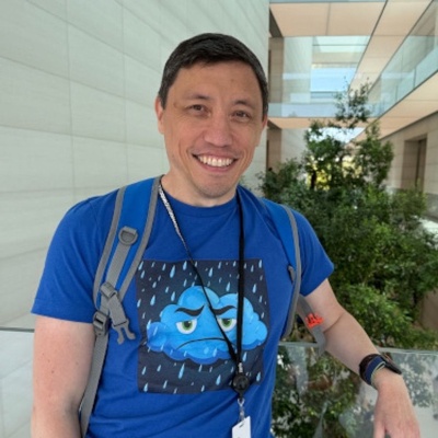 A picture of me at Apple Park wearing a Please Don’t Rain shirt.