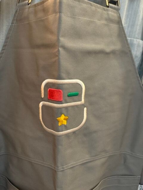 Picture of an apron with the Crouton app icon on it.